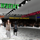 Models walk under signs that read "consent" and "women raise the upraising" at the Dior fall-winter 2021 show